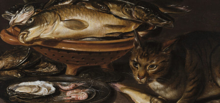 Still life painting features a reddish ceramic colander with several types of fish. In the foreground, a cat stands alert next to shrimp and oyster shells on a gleaming pewter dish.