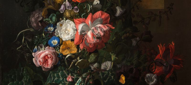 A still-life painting featuring an asymmetrical arrangement of flowers; the central section features pink, orange, yellow, and blue flowers and is dramatically highlighted compared to the background and outer edge of arrangement.