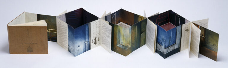 An accordion-style artist’s book is unfolded, displaying pages with illustrations and text on a white background. The pages alternate between colorful drawings and written passages, with the book covers at either end.