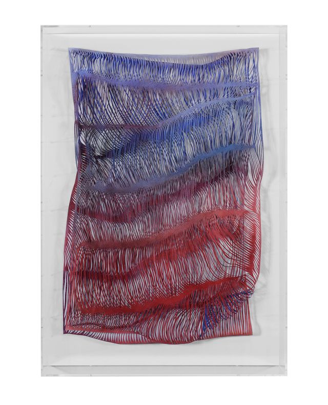 A rectangular paper work in a plexiglass box that shows thousands of slashes through the work to create waves and shadows throughout the surface. The color shifts from purple at the top to blue to red at the bottom.