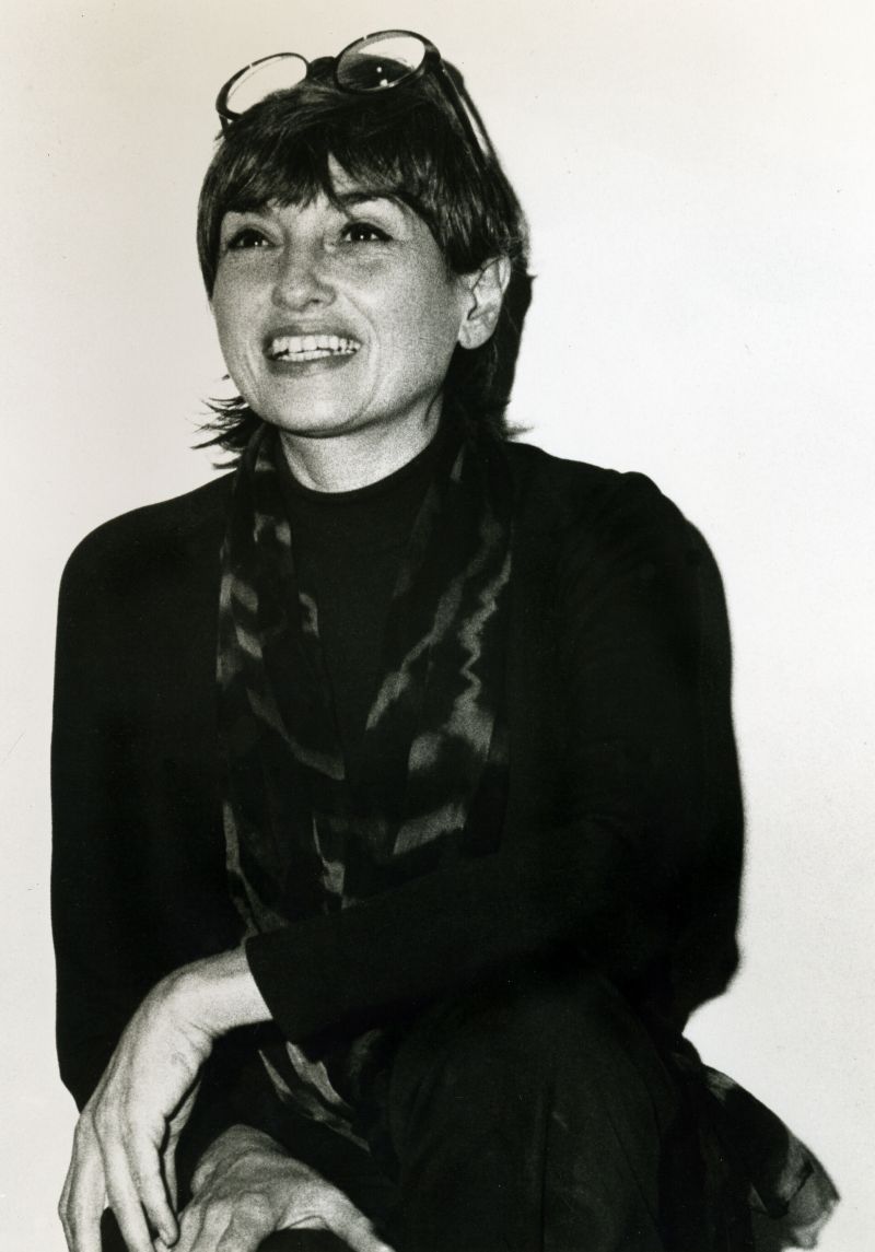 Black- and- white photographic portrait of a woman with a light complexion and dark, shoulder-length hair.